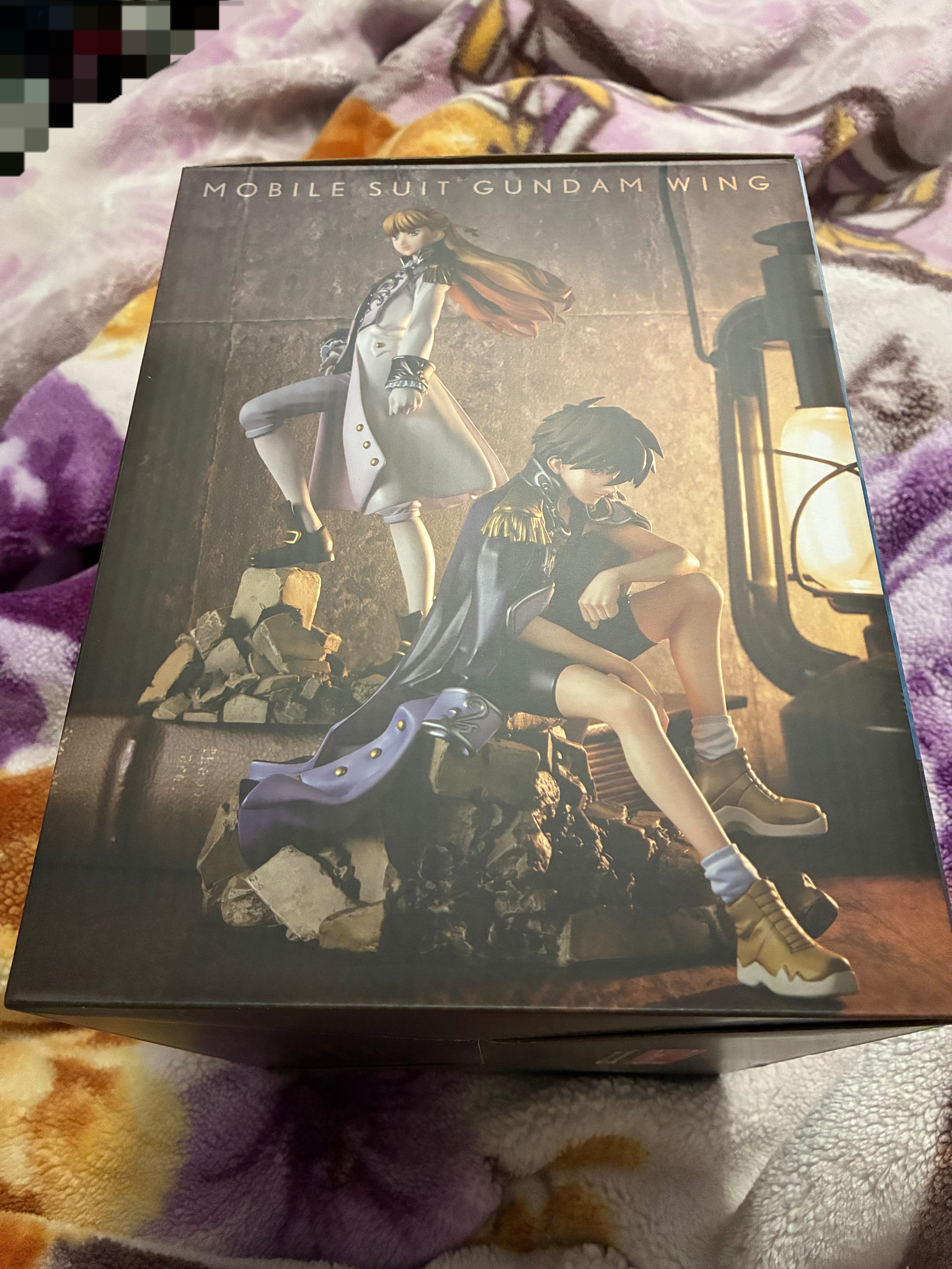 Side of Gundam wing Heero and Relena figures box showing the figures lit with lantern light.